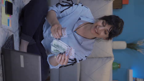 Vertical-video-of-Home-office-worker-woman-counting-money-funny-and-funny.